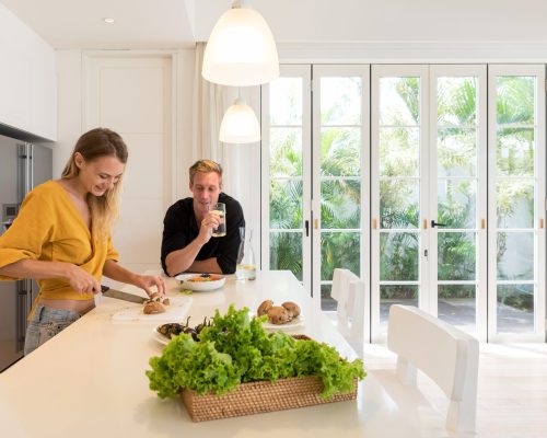woman-prepares-food-with-man-watching-in-kitchen-2026-01-06-10-54-52-utc (1)